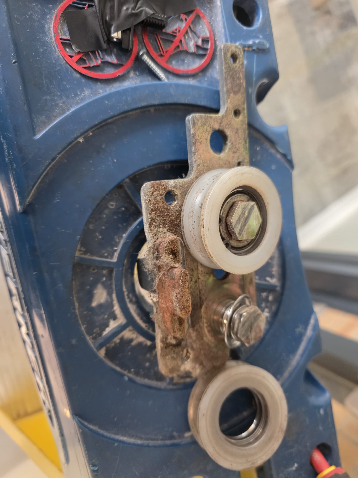 Worn roller and corroded bracket identified during inspection