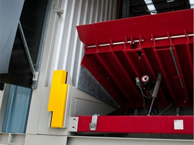Tall high-visibility dock buffer installed beside a loading bay