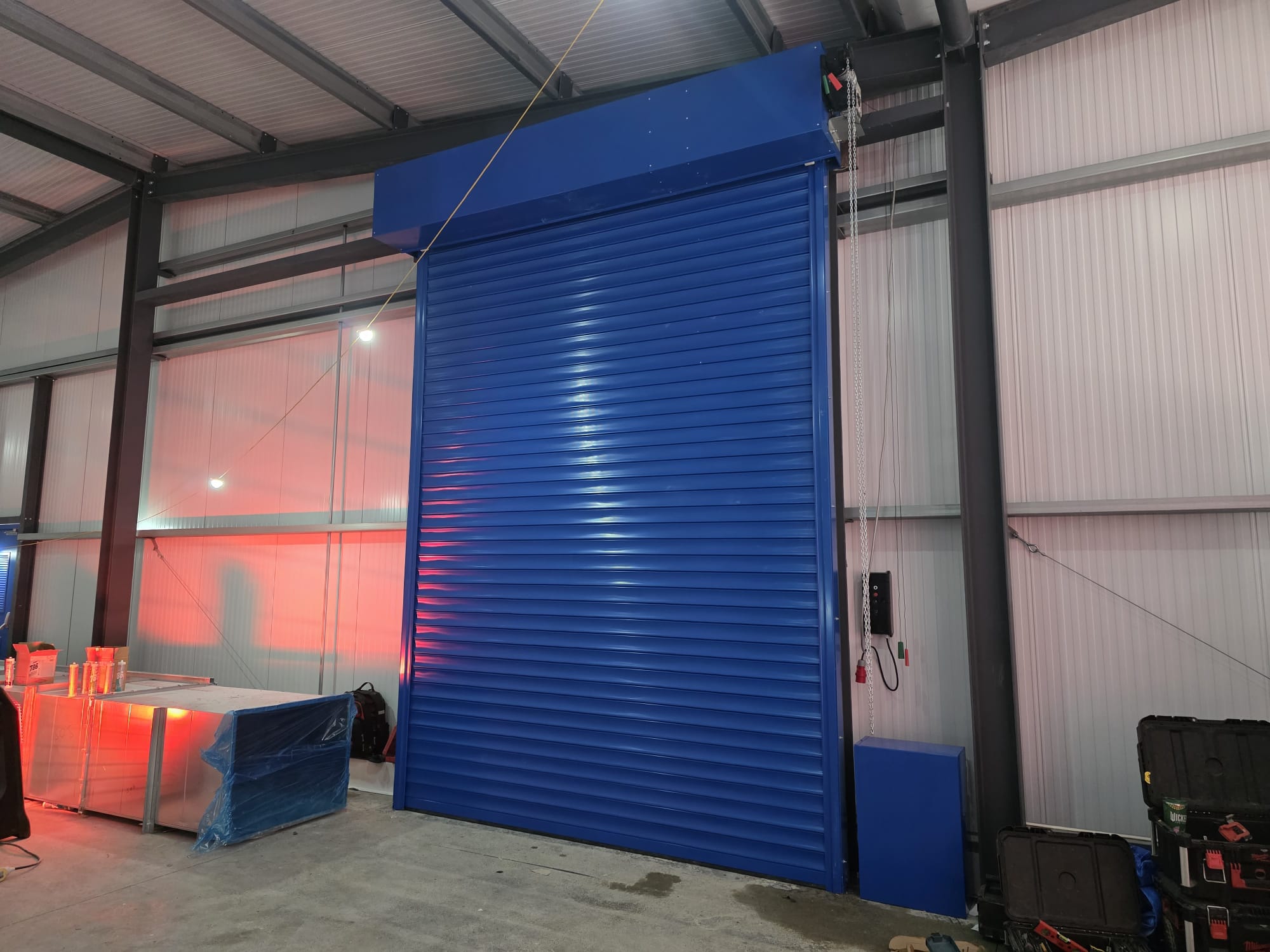 Blue industrial roller shutter door installed by EVICK
