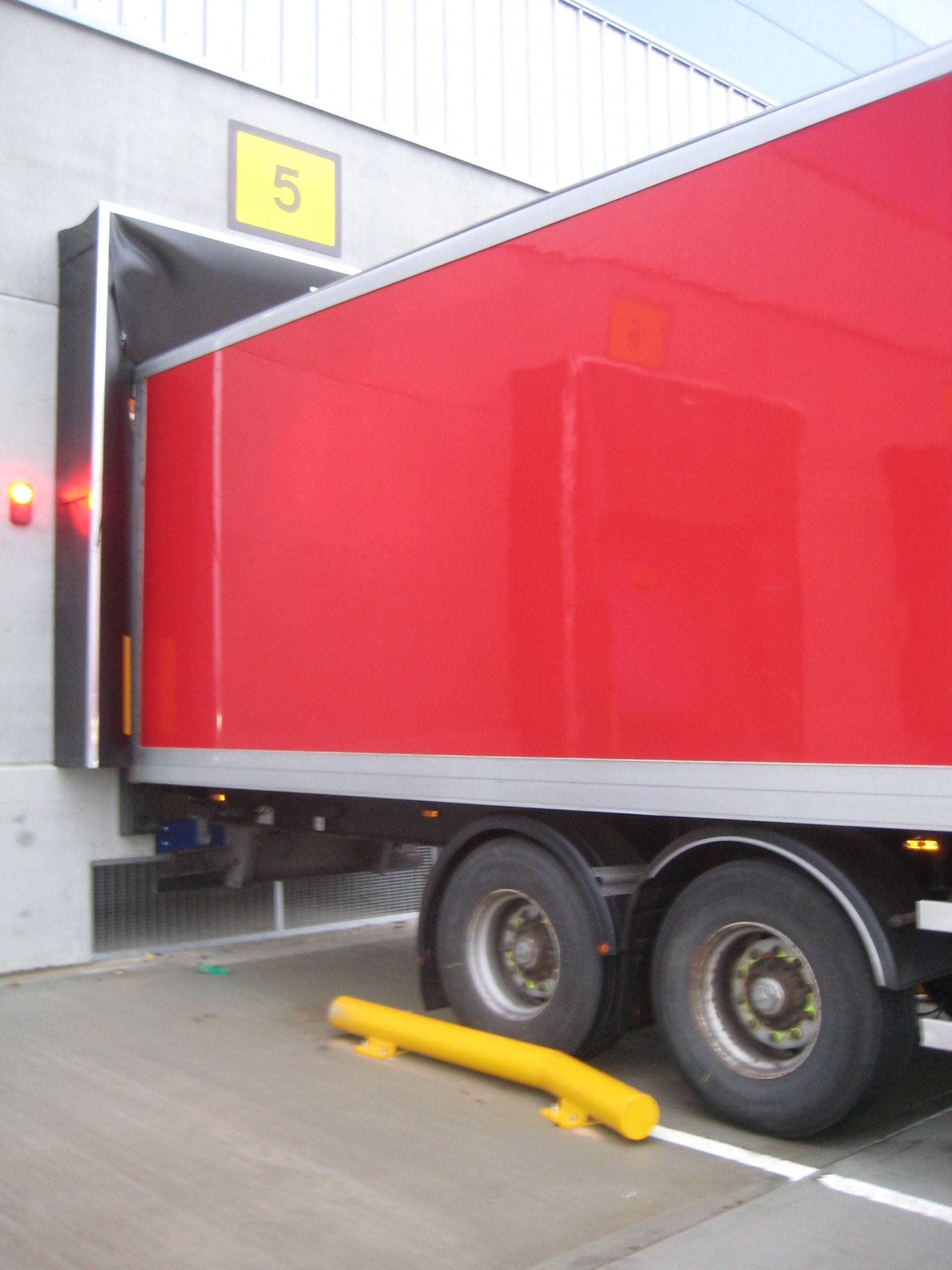 Lorry reversing alongside a flared wheel guide